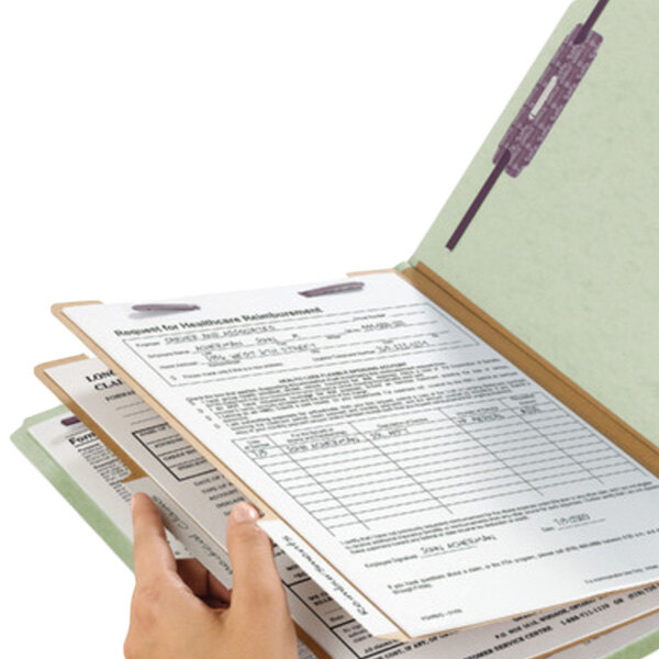 A hand holding a Smead SafeSHIELD letter size classification folder