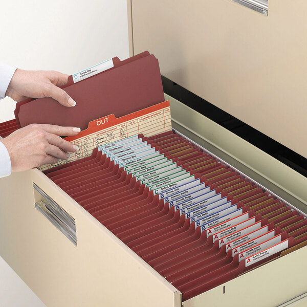 A person opening a file drawer with Smead letter size classification folders.