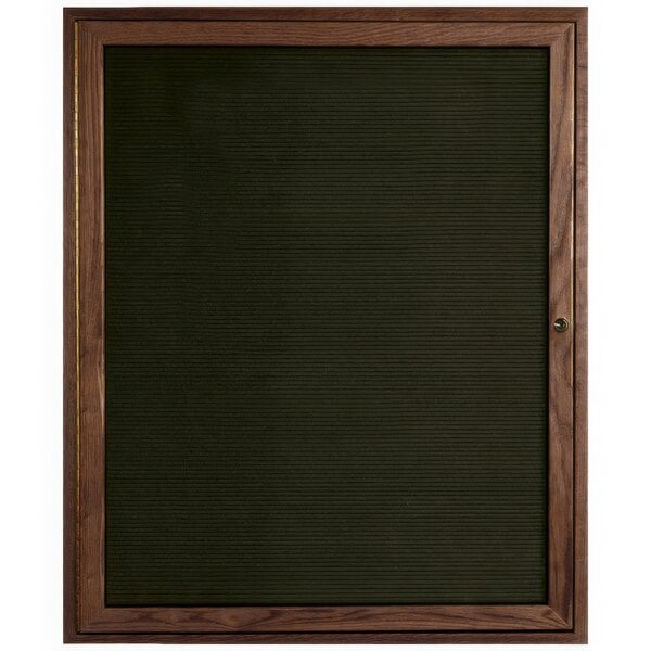 An Aarco walnut-framed enclosed black felt message board.