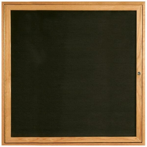 A wooden frame with a black felt message board behind it.