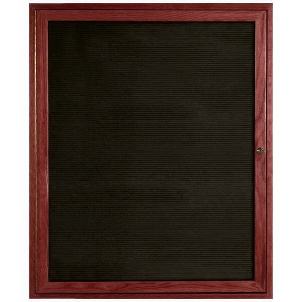 A black board with a wooden frame and enclosed door.