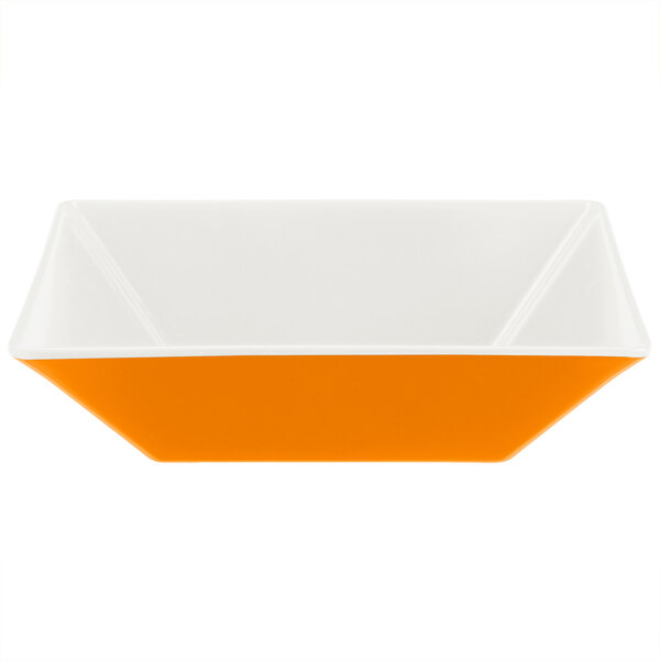 A white square bowl with orange and white interior.