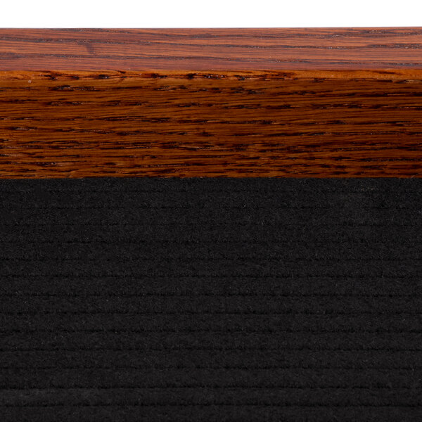 A close up of a wood frame on a table.