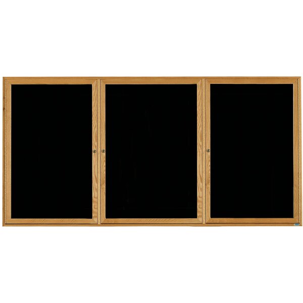 A black board with a natural oak wooden frame and three black felt doors.