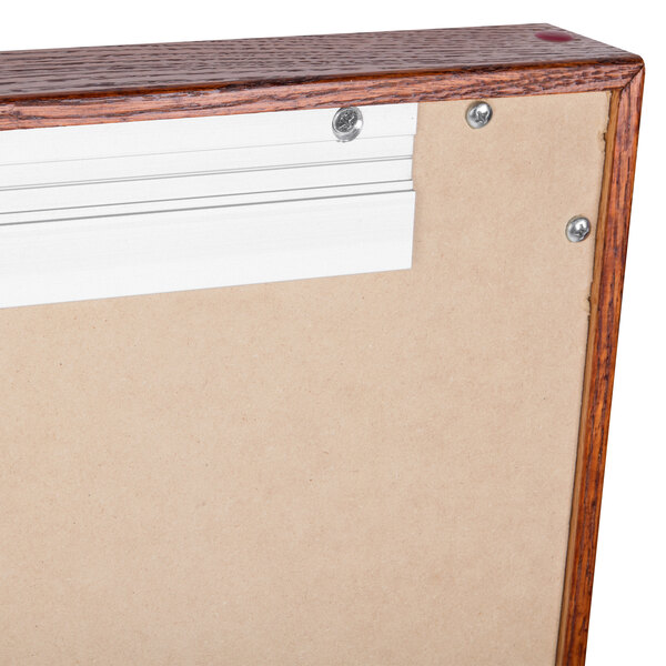 An Aarco cherry wood framed 3 door black felt message board.