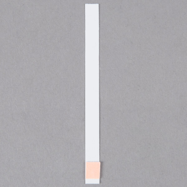 A white Purell test strip with a pink band.