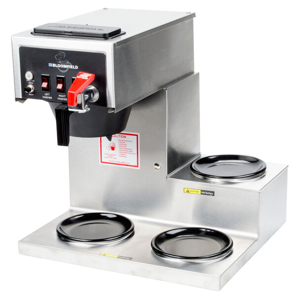 A Bloomfield automatic coffee brewer with three black warming plates on a counter.