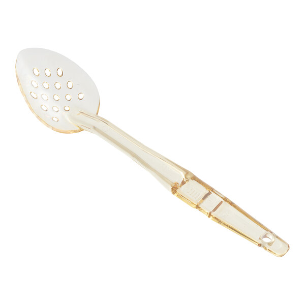 A Cambro amber plastic spoon with a perforated handle.