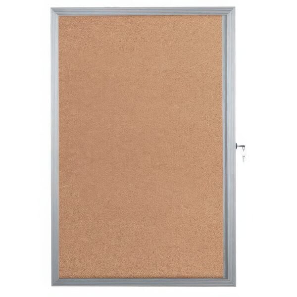 An Aarco cork bulletin board with an aluminum frame and key lock.