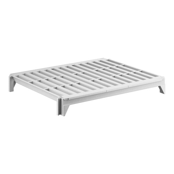 A white plastic shelf with vented holes.