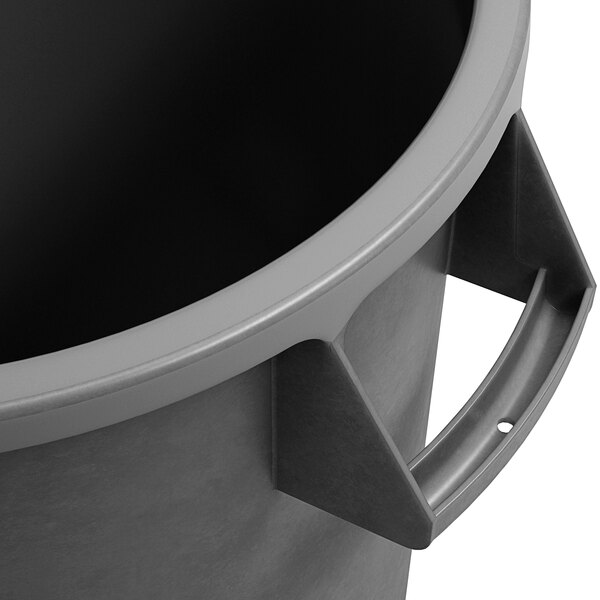 A close up of a Carlisle gray round trash can with a handle.