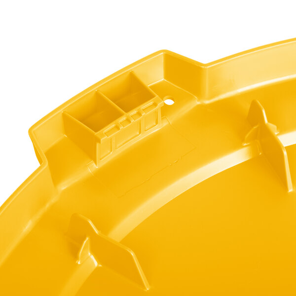 A yellow plastic lid for a round trash can.