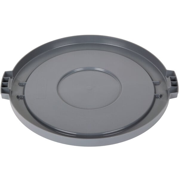 A grey plastic lid for a round trash can with a circle in the middle.