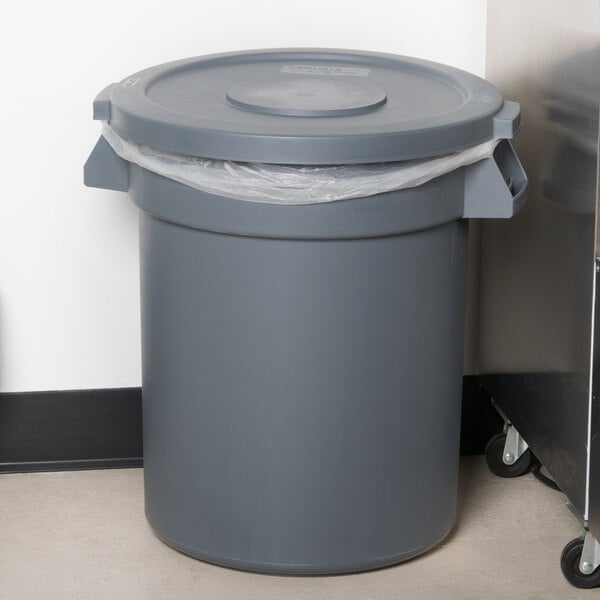 A Carlisle gray trash can lid on a gray trash can.