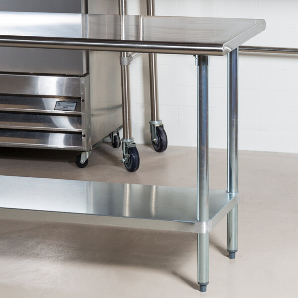 An Advance Tabco stainless steel work table with a galvanized steel undershelf.