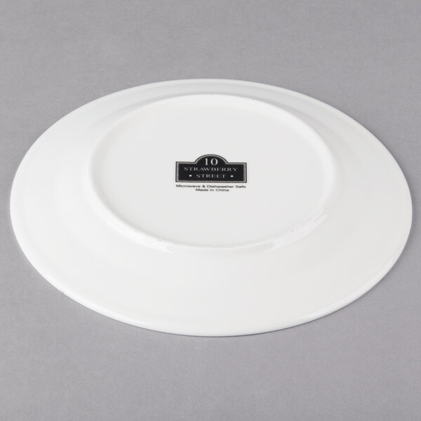 A white 10 Strawberry Street Whittier porcelain plate with black text on it.