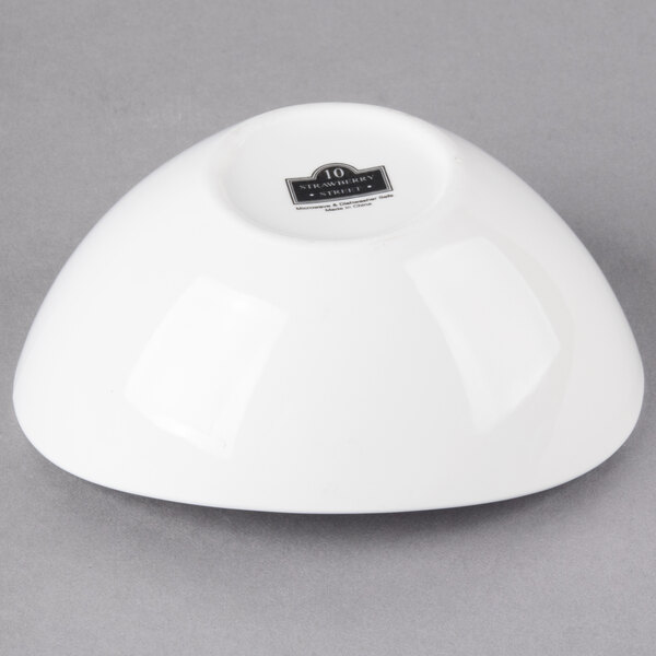 A white 10 Strawberry Street Whittier porcelain boat bowl on a gray background.