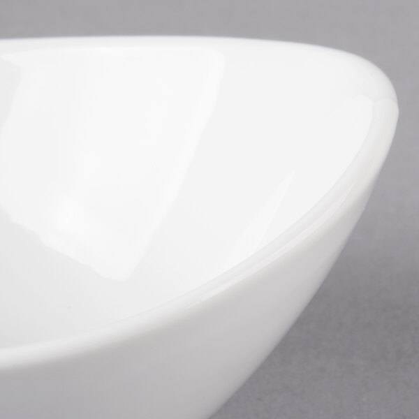 A 10 Strawberry Street Whittier white porcelain boat bowl with a curved edge.