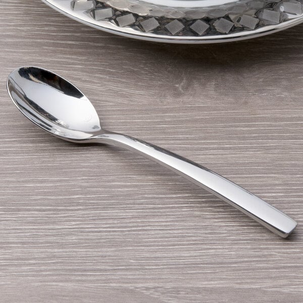 A Chef & Sommelier stainless steel demitasse spoon on a table.