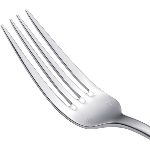 A close-up of a Chef & Sommelier Renzo stainless steel dinner fork with four forks on it.
