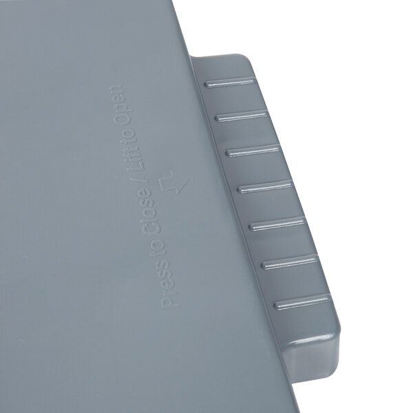 A close-up of a grey Rubbermaid lid with a handle.