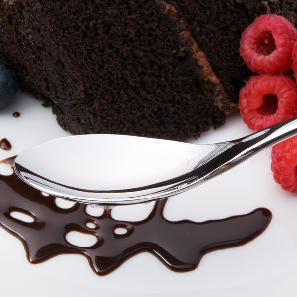 A Chef & Sommelier stainless steel dessert spoon on a plate with chocolate sauce and berries.