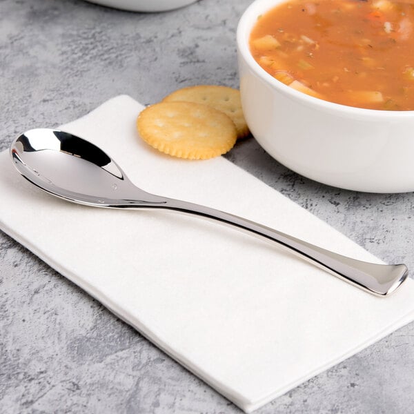 A Chef & Sommelier stainless steel soup spoon in a bowl of soup with crackers.