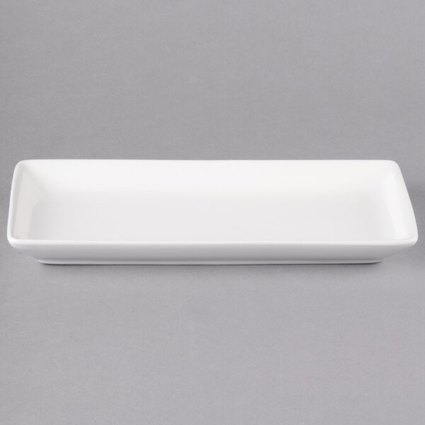 A white rectangular porcelain coupe platter with a handle.