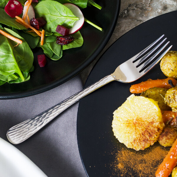 A plate of food with a Libbey Aspire medium weight dinner fork.