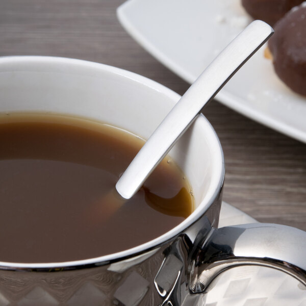 A demitasse spoon in a cup of coffee.
