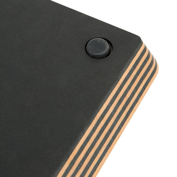 A black rectangular Epicurean wood fiber cutting board with brown stripes.