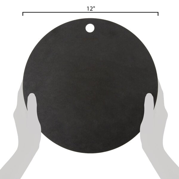 A round black Epicurean Richlite wood fiber pizza board with a hole in the center.
