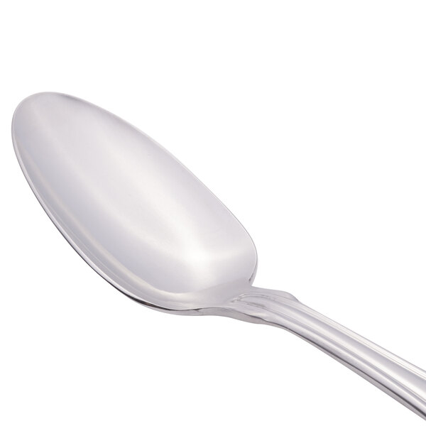 A close-up of a Libbey Kings stainless steel serving spoon with a silver handle.
