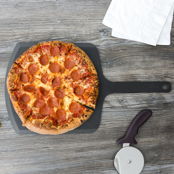 A pepperoni pizza on an Epicurean Richlite wood pizza peel with a black handle.