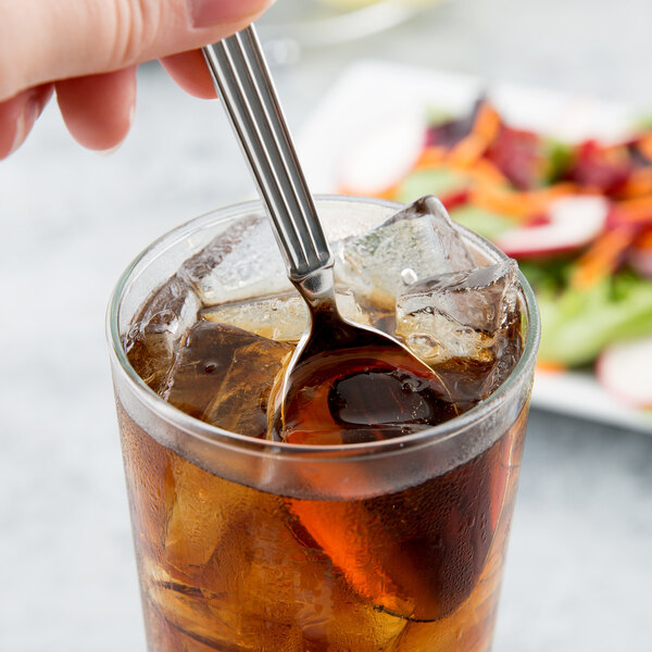 A Libbey stainless steel iced tea spoon in a glass of ice tea.