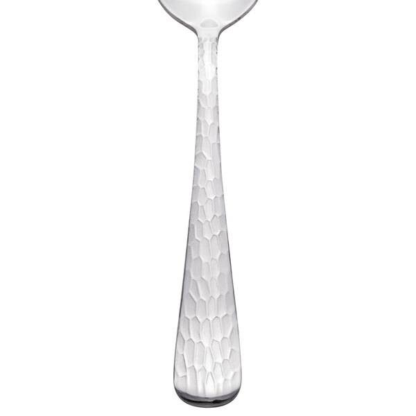 A Libbey stainless steel teaspoon with a textured pattern on the handle.