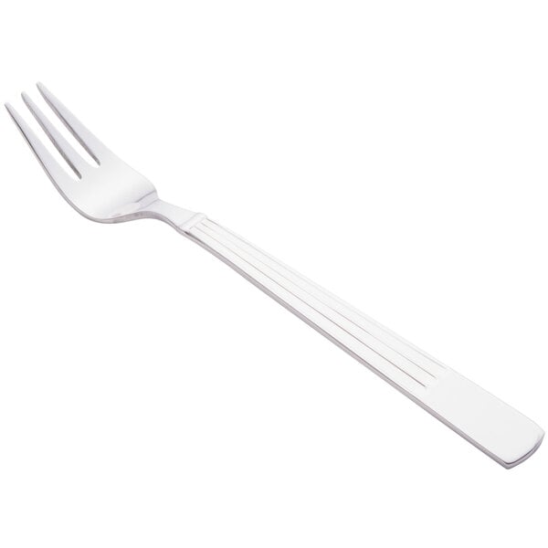 A silver Libbey cocktail fork with a white background.