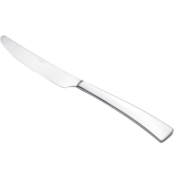 An Arcoroc stainless steel dinner knife with a silver handle.