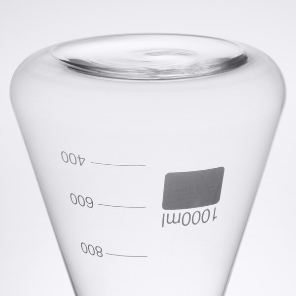 An American Metalcraft Erlenmeyer flask with a clear cap on a counter.