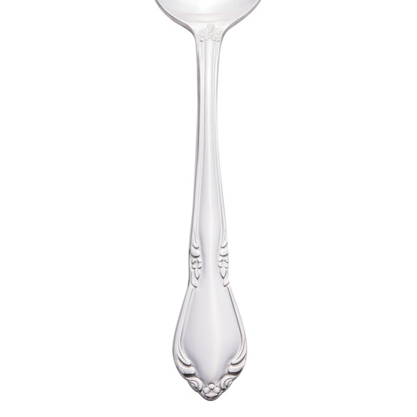 A Libbey stainless steel dessert spoon with a design on the handle.
