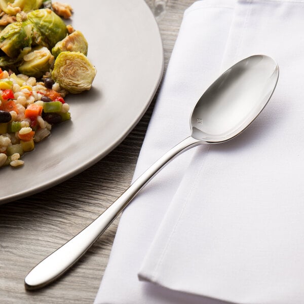 A plate of food with a Chef & Sommelier stainless steel dinner spoon on it.