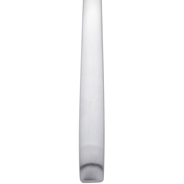 A close up of an Arcoroc stainless steel dinner spoon with a white handle.