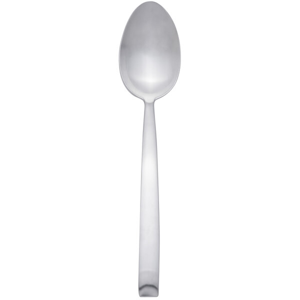 An Arcoroc stainless steel dinner spoon with a white handle.