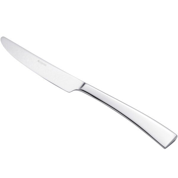 An Arcoroc stainless steel dessert knife with a silver handle.