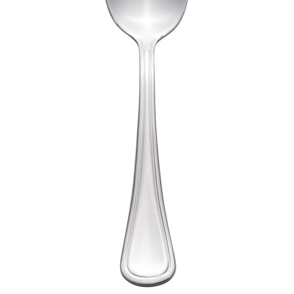 A close-up of a Libbey stainless steel demitasse spoon with a white handle.