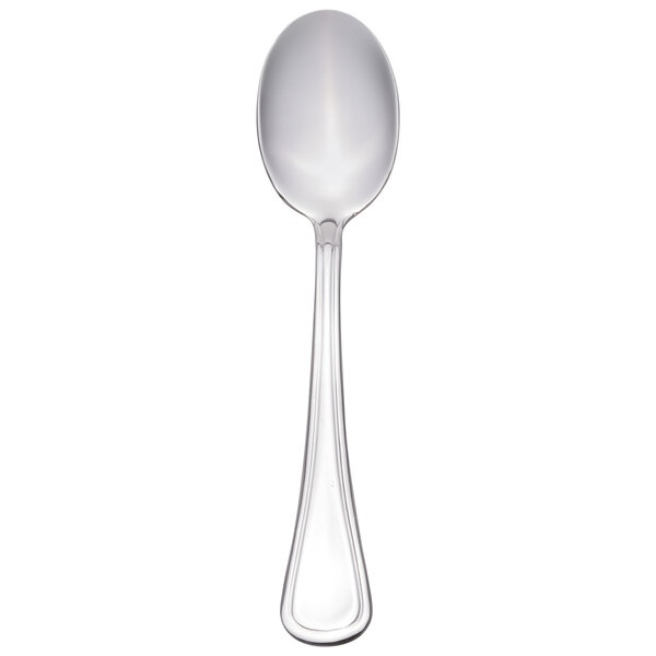 A silver Libbey demitasse spoon with a white handle.