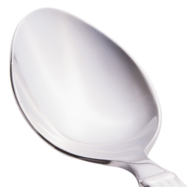 A close-up of a Libbey stainless steel teaspoon with a silver handle.