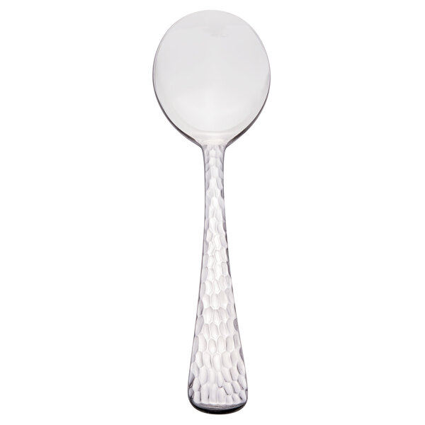 A Libbey stainless steel bouillon spoon with a white handle and silver spoon.