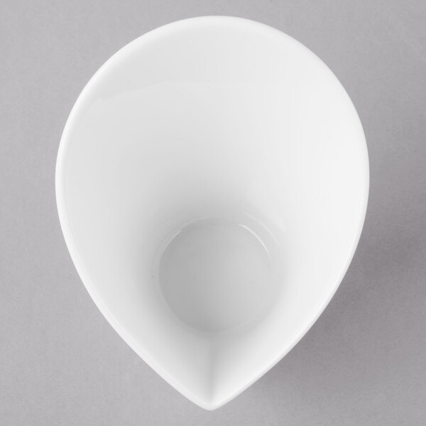 A close-up of a white Schonwald Calla bowl with a cone-shaped design.