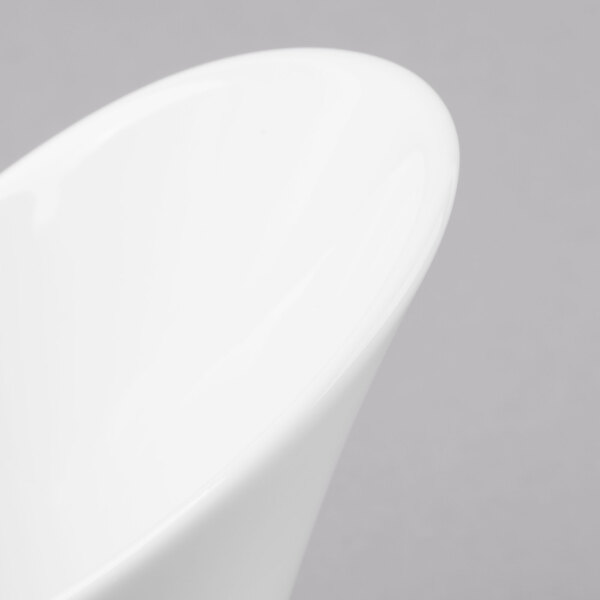 A close-up of a Schonwald Calla bowl with a curved edge on a white surface.